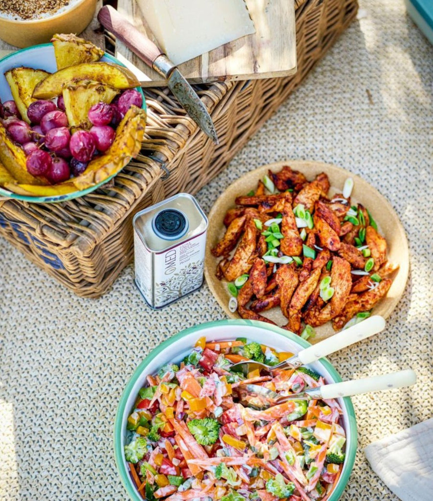 O-med EVOO picnic scene with salads in Deliberico