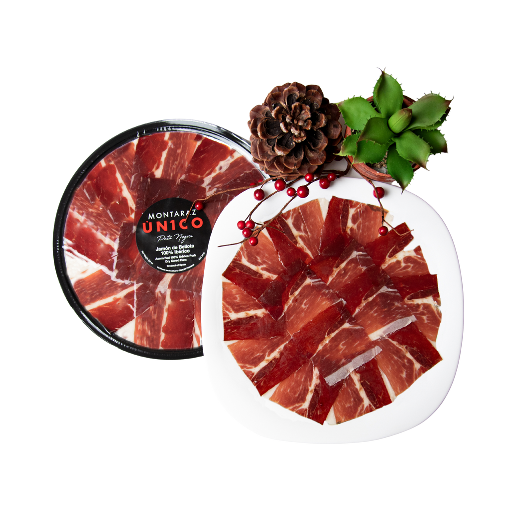 100% Iberico Acorn-fed Ham Hand Carved Style plate and packaged plate with pinecone and green cactus by Montaraz. Deliberico