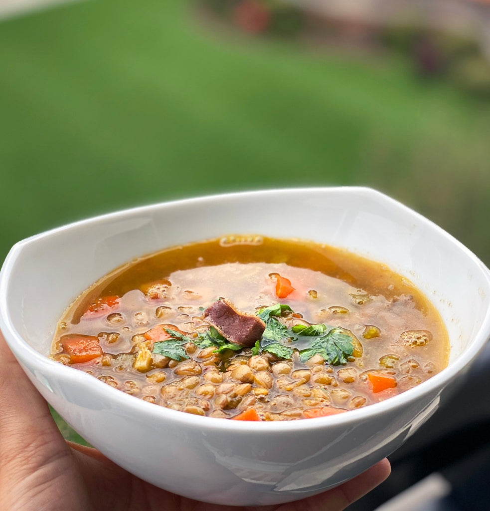 Lentil soup bowl with iberico ham on top by Fermin. Deliberico
