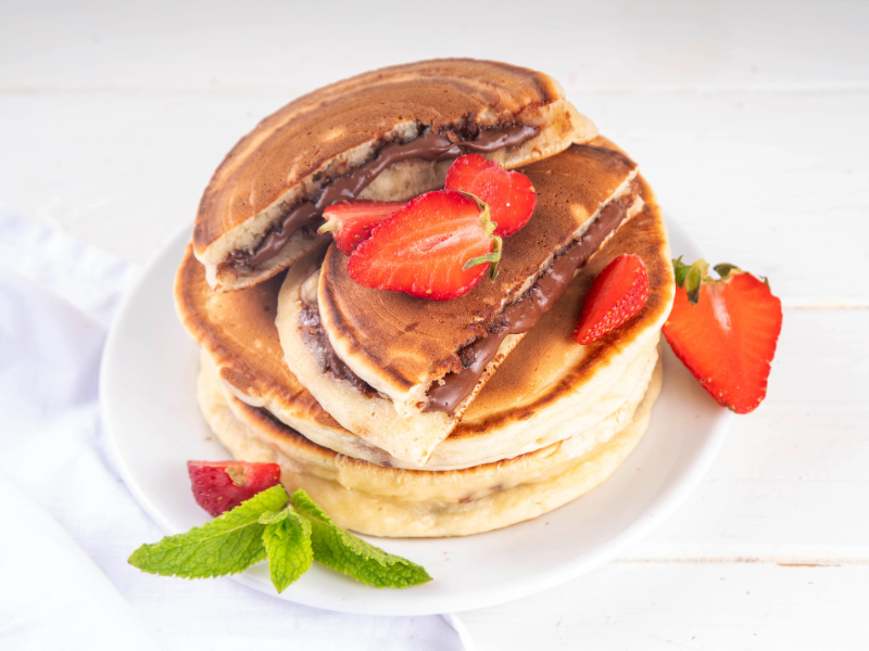 Pancakes with nocilla and strawberries and mint on the side recipe