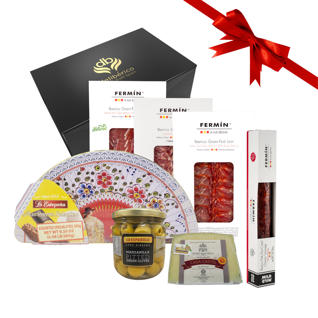 All I Want for Christmas Gift Box — a luxurious Spanish selection of Iberico charcuterie, Manchego cheese, olives, and festive pastries in Deliberico´s elegant black and gold packaging.