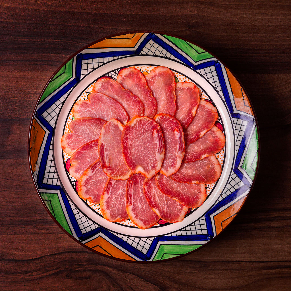 Iberico grain fed loin on a ceramic colorful plate by Fermin. Deliberico