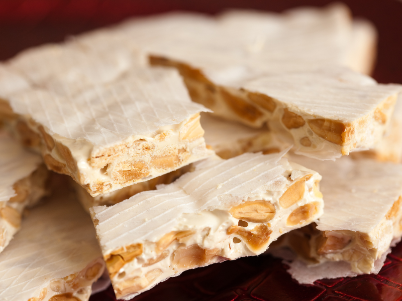 Close-up of a stack of Alicante nougat on a dark surface