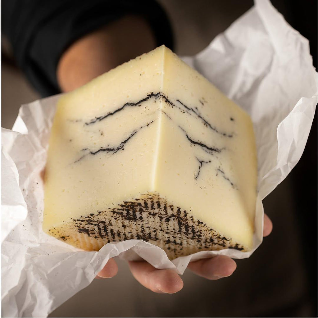 Close-up of a cheese with truffle from Vega Sotuelamos