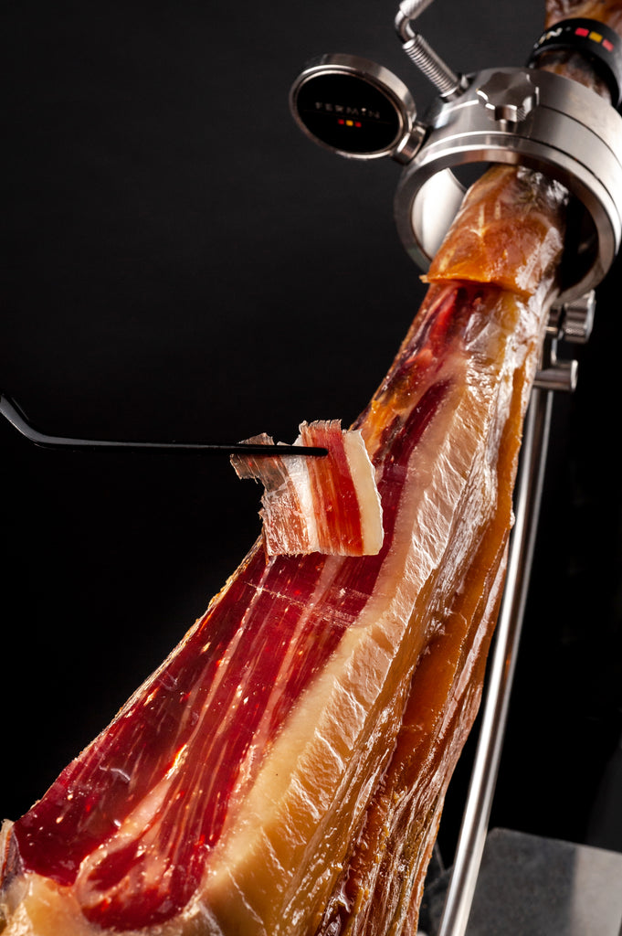 Iberico shoulder on a holder and a piece of carved ham by Fermin. Deliberico