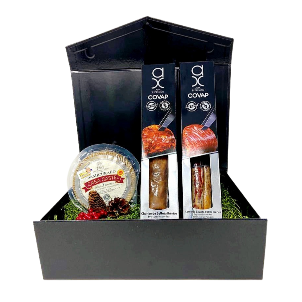 Black gift box with one Alta expresion COVAP iberico loin in white and black box, one Alta expresion COVAP chorizo in white and black box and a Casa Castel Manchego cheese wheel by Deliberico