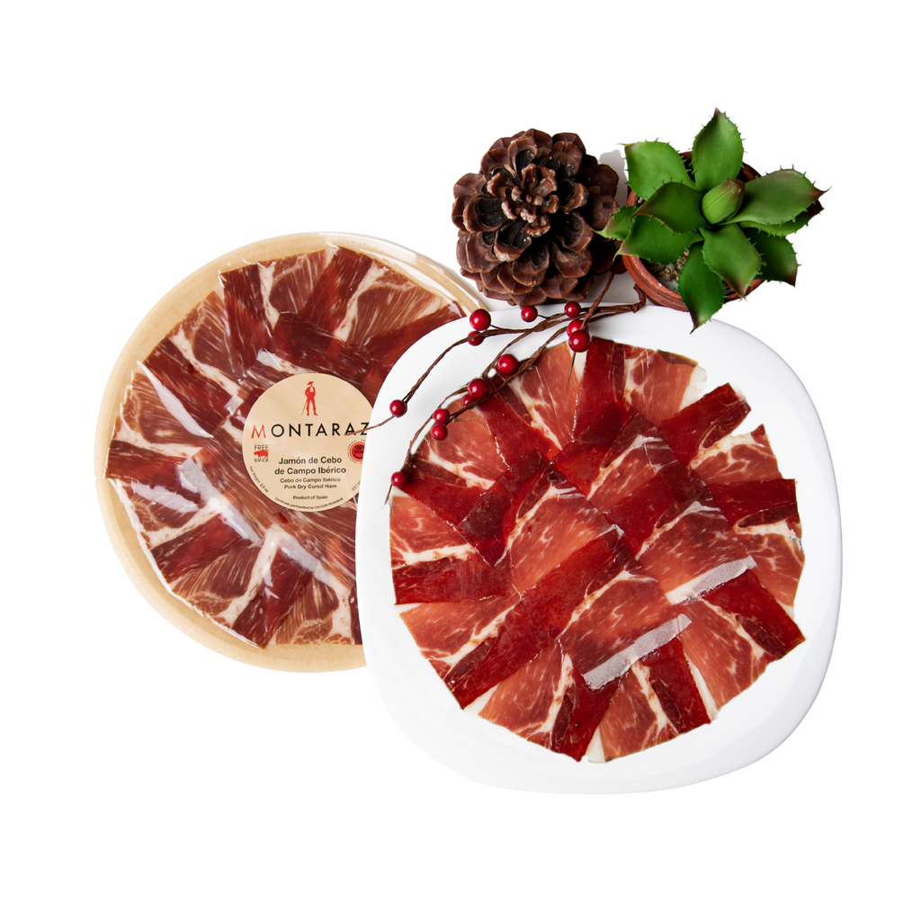 Free range Iberico Acorn-fed Ham Hand Carved Style plate and packaged plate with pinecone and green cactus by Montaraz. Deliberico